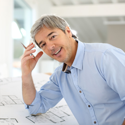 business owner leaning over planning documents